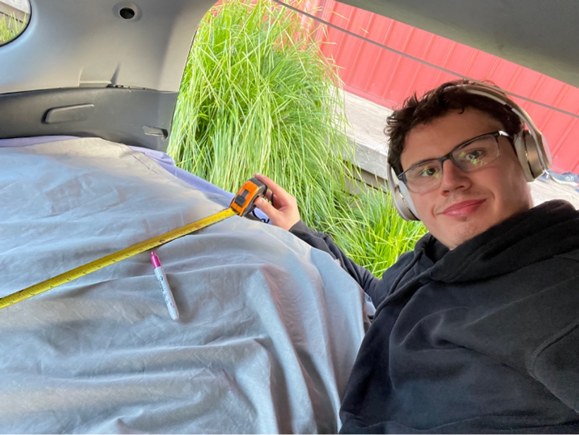 A man making car curtains 